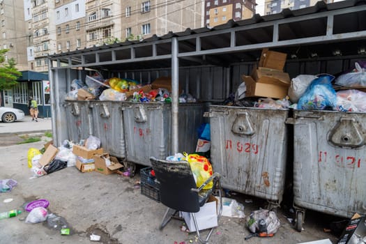 overfilled public trash bins at summer day in Bishkek, Kyrgyzstan - May 24, 2023