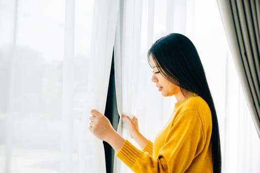 A young woman wakes up early opening the curtains smiling at the serene view feeling refreshed and relaxed at home. Embracing morning joy relaxation and a cheerful start to the day.