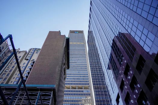 new york city manhattan skyscrapers view from the street to the top of the building on sunny clear day