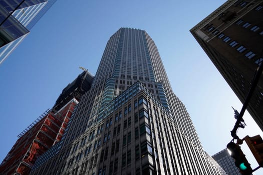 new york city manhattan skyscrapers view from the street to the top of the building on sunny clear day