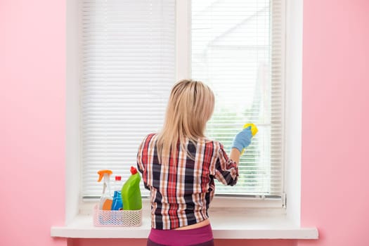 Woman cleaning and polishing with a spray detergent, housekeeping and hygiene concept.