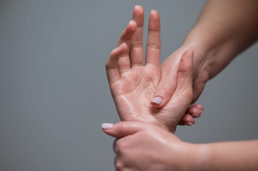 The masseuse massages the client's palms. Close-up of hands at a spa treatment