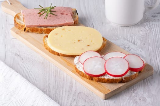 Sandwiches with radishes, cottage cheese, cheese and sausage.