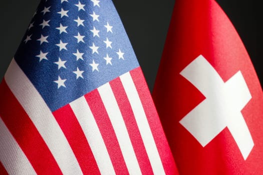 Nearby are the small flags of the USA and Switzerland.