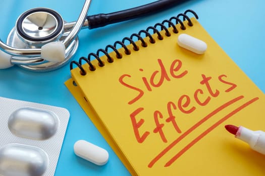 Medical pills and written note side effects.