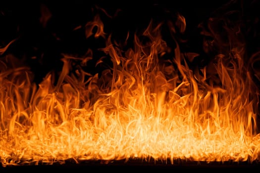 Hell flames, devil's mouth. fire banner. A background of scalding flames. Firestorm. Fire burning. Bright burning flames on a black background. Wall of Real fire, abstract background. Fire flames.