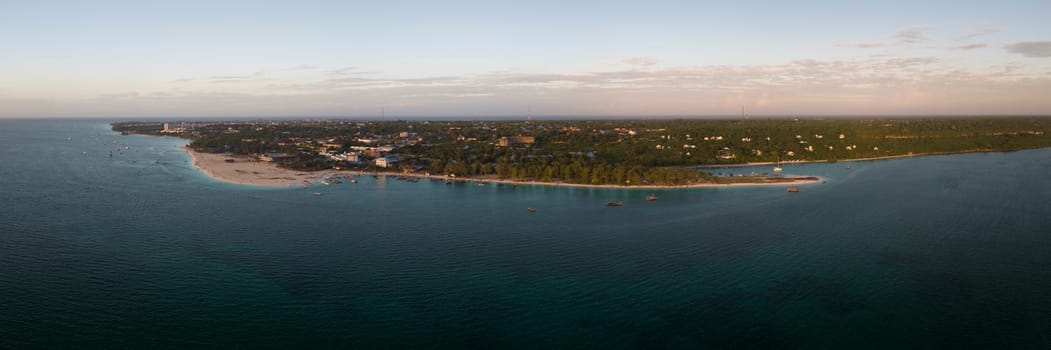 Panorama of kendwa beach and ocean on tropical sea coast with sandy beach.Wooden fishing boat near the shore. Summer travel in Zanzibar, Africa,Tanzania.