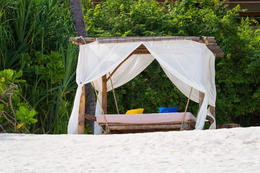 Luxury beach canopies at sunset.White beach tents at luxurious resort. Summer beach concept, carefree, rest seaside, Wonderful garden on the back.