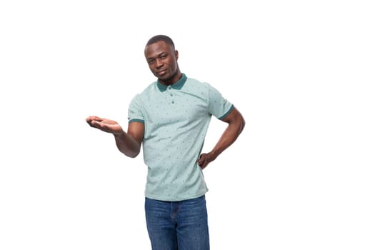 portrait of a young positive short-haired american man dressed in a mint summer t-shirt on a white background.