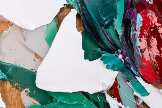 Fragment of multicolored texture painting on plywood. Abstract art background. oil on canvas. Rough brushstrokes of paint. Closeup of a painting by oil and palette knife. Highly-textured, high quality details.