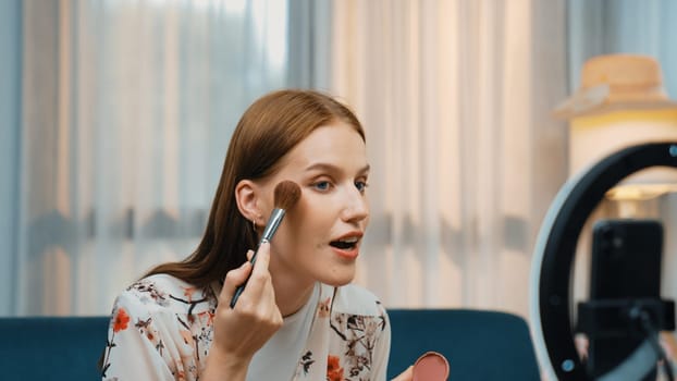 Woman influencer shoot live streaming vlog video review makeup prim social media or blog. Happy young girl with cosmetics studio lighting for marketing recording session broadcasting online.