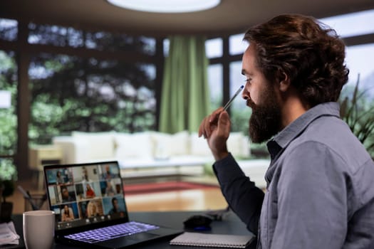 Director discusses new global tactics with his project team, connecting on online videocall from his mountain vacation home. Company leader meeting with affiliates about enterprise development.