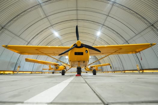 Yellow airplane glider in the hangar