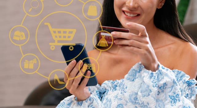 Elegant customer wearing blue dress controlling device choosing online platform. Smart consumer watching gadget opening e-commerce application using cashless technology shopping inventory. Cybercash.