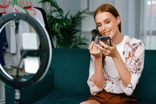 Woman influencer shoot live streaming vlog video review makeup utmost social media or blog. Happy young girl with cosmetics studio lighting for marketing recording session broadcasting online.