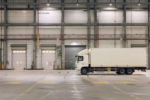 white truck in warehouse with many boxes, Shipping Warehouse and Truck Transportation.