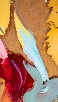 Fragment of multicolored texture painting on plywood. Abstract art background. oil on canvas. Rough brushstrokes of paint. Closeup of a painting by oil and palette knife. Highly-textured, high quality details.