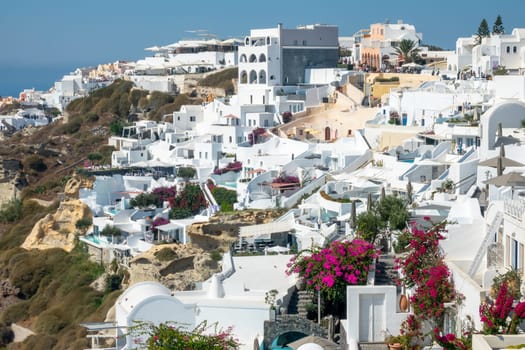 Greece. Sunny summer day in the Santorini caldera. White hotel buildings on the terraces of Oia