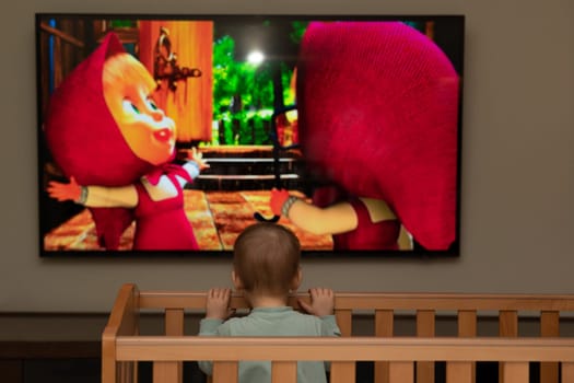 Large figures on the screen. The concept of a child's loneliness when watching cartoons without the