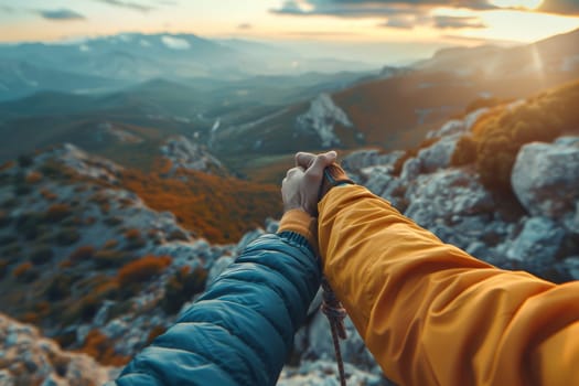 Two people are holding hands on a mountain top. The scene is peaceful and romantic, with the beautiful mountain range in the background