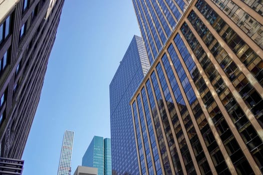 new york city manhattan skyscrapers view from the street to the top of the building on sunny clear day