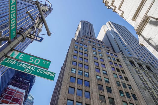 new york city manhattan skyscrapers view from the street to the top of the building on sunny clear day