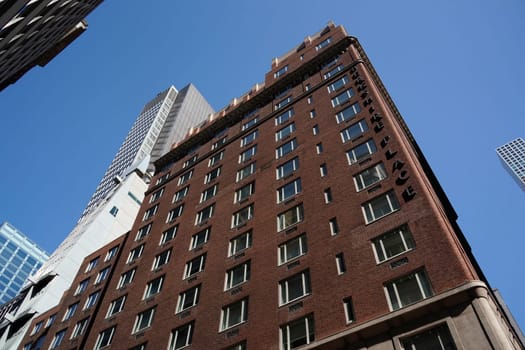 new york city manhattan skyscrapers view from the street to the top of the building on sunny clear day