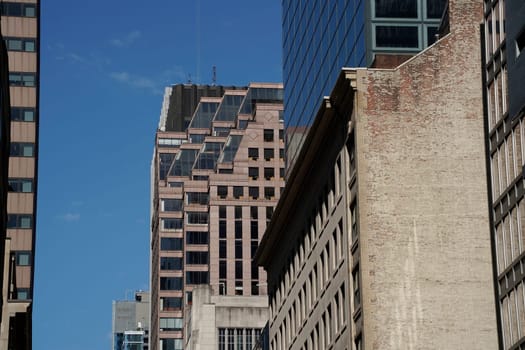 new york city manhattan skyscrapers view from the street to the top of the building on sunny clear day