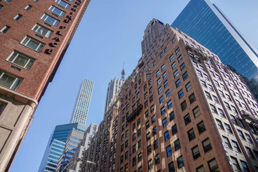 new york city manhattan skyscrapers view from the street to the top of the building on sunny clear day