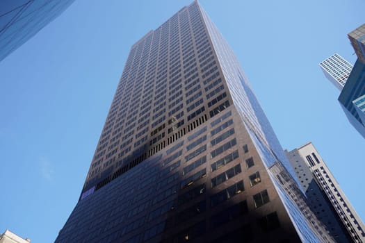 new york city manhattan skyscrapers view from the street to the top of the building on sunny clear day