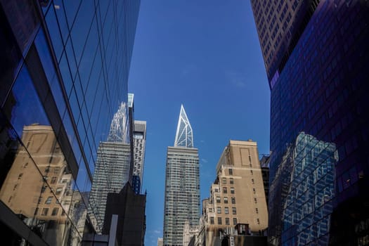 new york city manhattan skyscrapers view from the street to the top of the building on sunny clear day