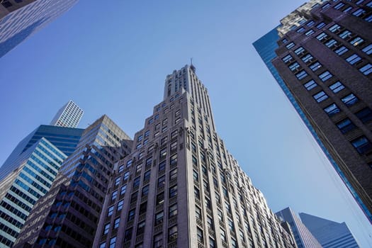 new york city manhattan skyscrapers view from the street to the top of the building on sunny clear day