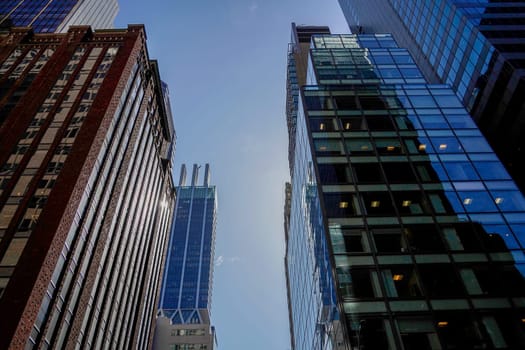 new york city manhattan skyscrapers view from the street to the top of the building on sunny clear day