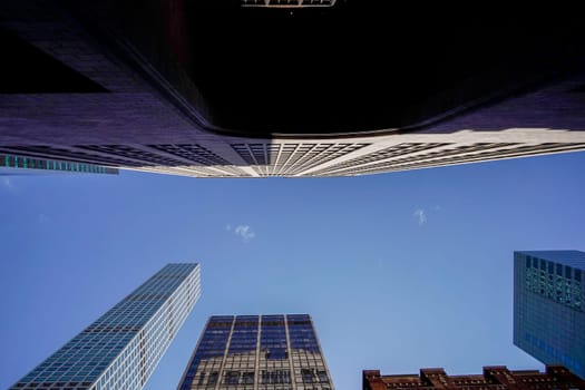 new york city manhattan skyscrapers view from the street to the top of the building on sunny clear day