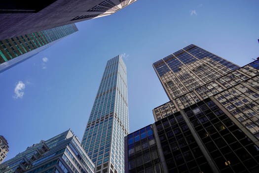 new york city manhattan skyscrapers view from the street to the top of the building on sunny clear day