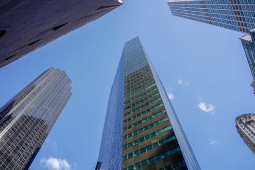 new york city manhattan skyscrapers view from the street to the top of the building on sunny clear day