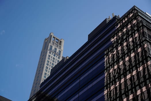 new york city manhattan skyscrapers view from the street to the top of the building on sunny clear day