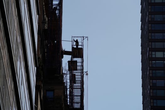 new york city manhattan skyscrapers view from the street to the top of the building on sunny clear day