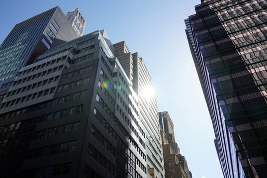 new york city manhattan skyscrapers view from the street to the top of the building on sunny clear day