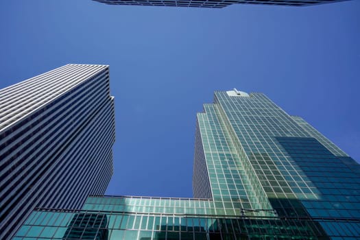 new york city manhattan skyscrapers view from the street to the top of the building on sunny clear day