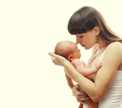 Happy young mother holding cute infant, baby sleeping in arms on white studio background