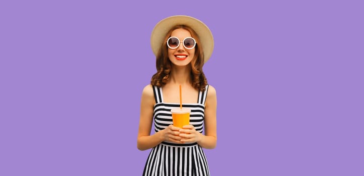 Summer portrait of happy smiling young woman with fresh juice in straw hat on purple studio background