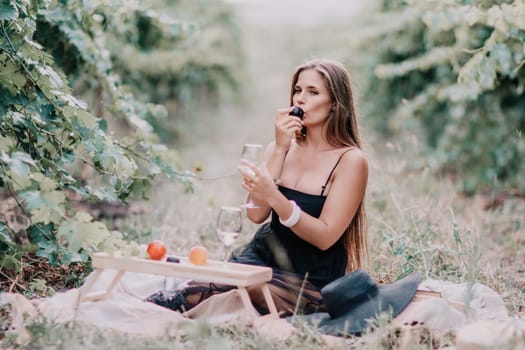 Picnic and wine tasting at sunset in the hills of Italy, Tuscany. Vineyards and open nature in the summer. Romantic dinner, fruit and wine.