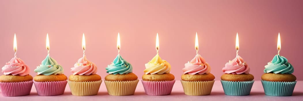 Colorful cupcakes with lit candles are displayed against a pink background, indicating an indoor celebration event marking of joy and celebrating. with free space.