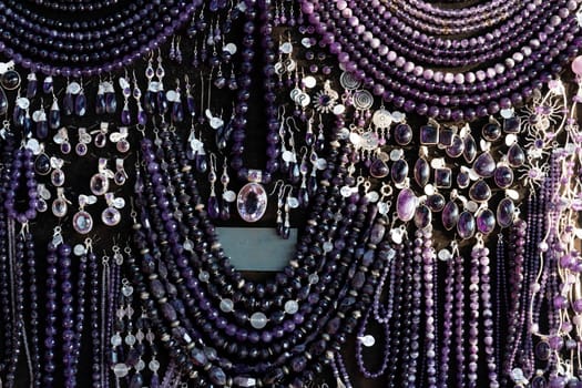 Amethyst necklage earrings jewelry on display stand in a shop market detail