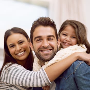 Mom, dad and kid in home for portrait with love or care, quality time and family bonding for memories or connection. Parents, girl child and together for comfort or safety on weekend, hug and closeup.
