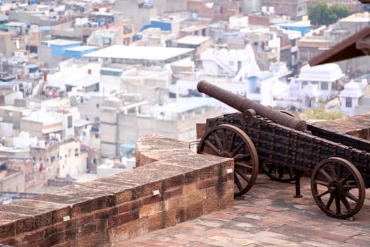 Ancient cannon with sheels shooting over the city of Jodhpur jaipur udaipur jaisalmer showing the fortifications and defences of ancient forts in Rajasthan India