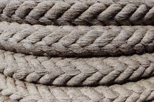 twisted braided rope closeup for natural textile background.