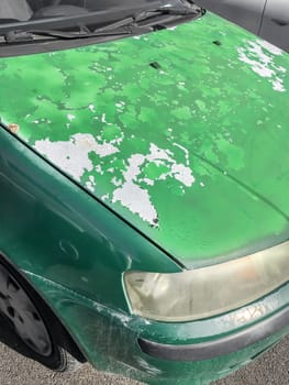 Cracked and peeling paint on an old car for background.