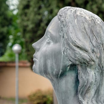 Sad woman statue. Praying woman statue. Shallow dof.